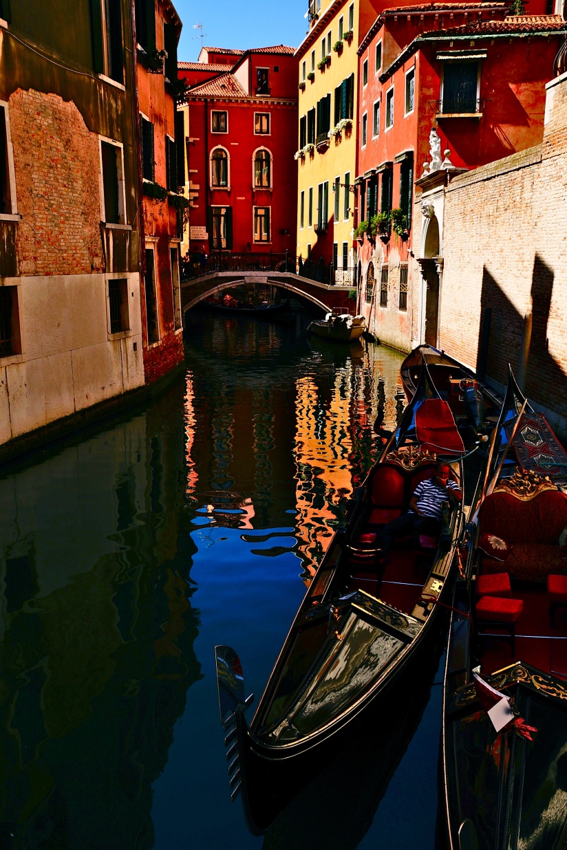 A gondolier finds a spot in the shade to rest on the canals of Venice. . . 